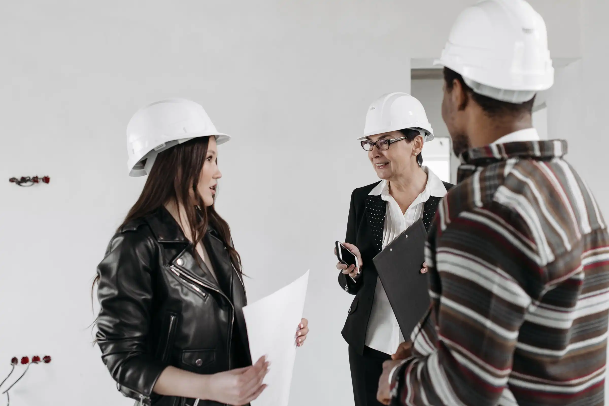 Site team in hard hats discussing a project